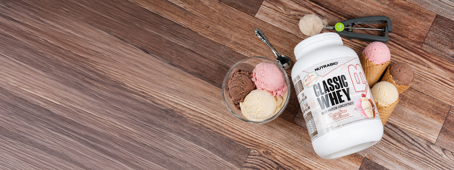 A photo of NutraBio Classic Whey limited edition Neapolitan Ice Cream on a counter top with Ice Cream scoops around it in a Large desktop size.