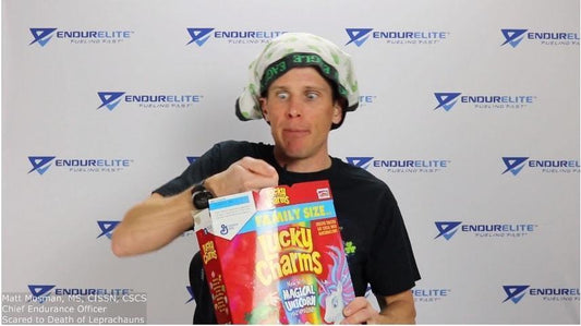 Matt Mossman making a goofy face and eating dry lucky charms out of a cereal box