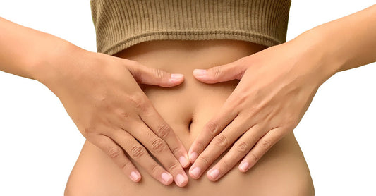 A person places their hands on their lower abdomen.