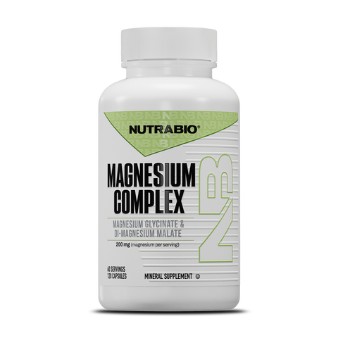 A white bottle of NutraBio Magnesium Complex (200mg), featuring a green and black label with product details, contains 120 capsules of high-absorption magnesium supplement.