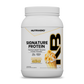 A white tub of Signature Protein banana crème whey protein isolate featuring an illustration of a banana-topped milkshake.