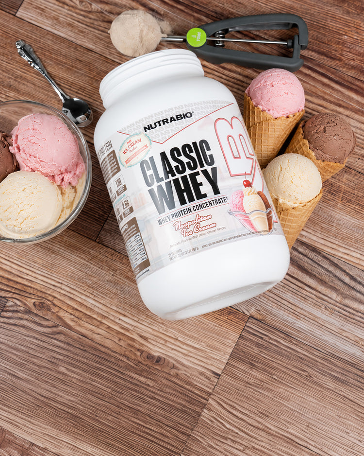 A photo of NutraBio Classic Whey limited edition Neapolitan Ice Cream on a counter top with Ice Cream scoops around it in Mobile Size.
