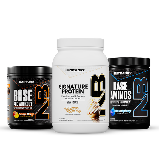 Essential Training Stack featuring three tubs of dietary supplement powder: a black container of orange mango pre-workout, a white container of premium protein, and a black container of blue raspberry essential amino acids.