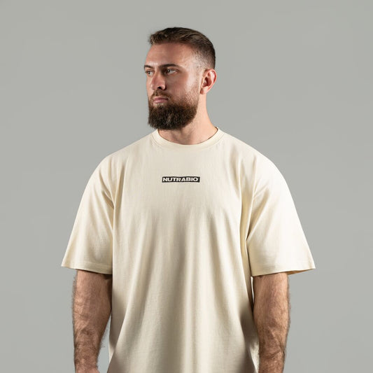 Man wearing a beige t-shirt with 'NUTRABIO' logo on a gray background