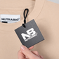 NUTRABIO tag on a beige garment with a hand holding a black card displaying the brand logo.
